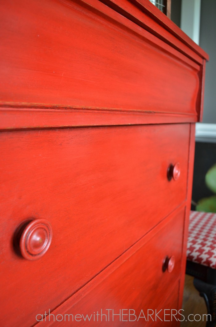 Red painted wood dresser using Annie Sloan Chalk Paint emperors silk close up of wax details.
