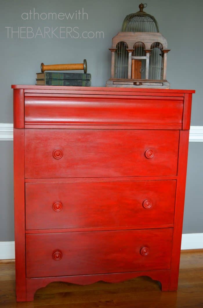 Red painted wood dresser using Annie Sloan Chalk Paint emperors silk  styled with books and vintage wood bird cage.