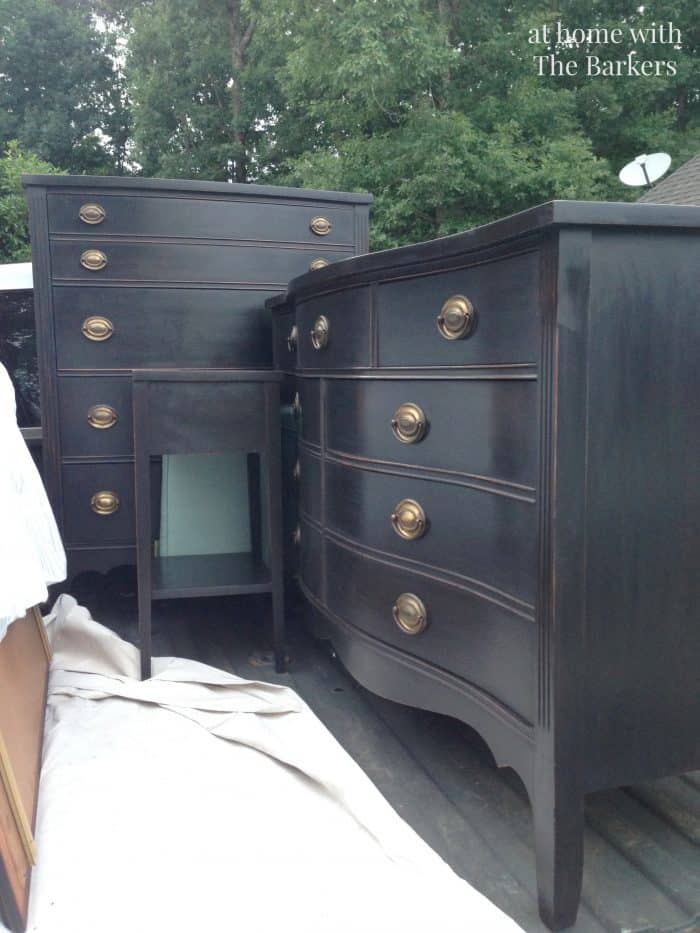 Black painted furniture loaded in truck for delivery.