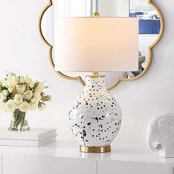 Modern paint splatter table lamp in front of mirror