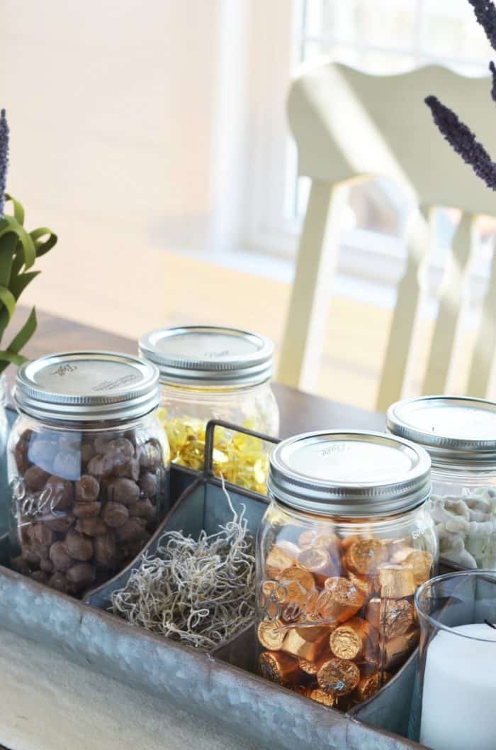 Galvanized farmhouse style tray filled with ball jars of candy