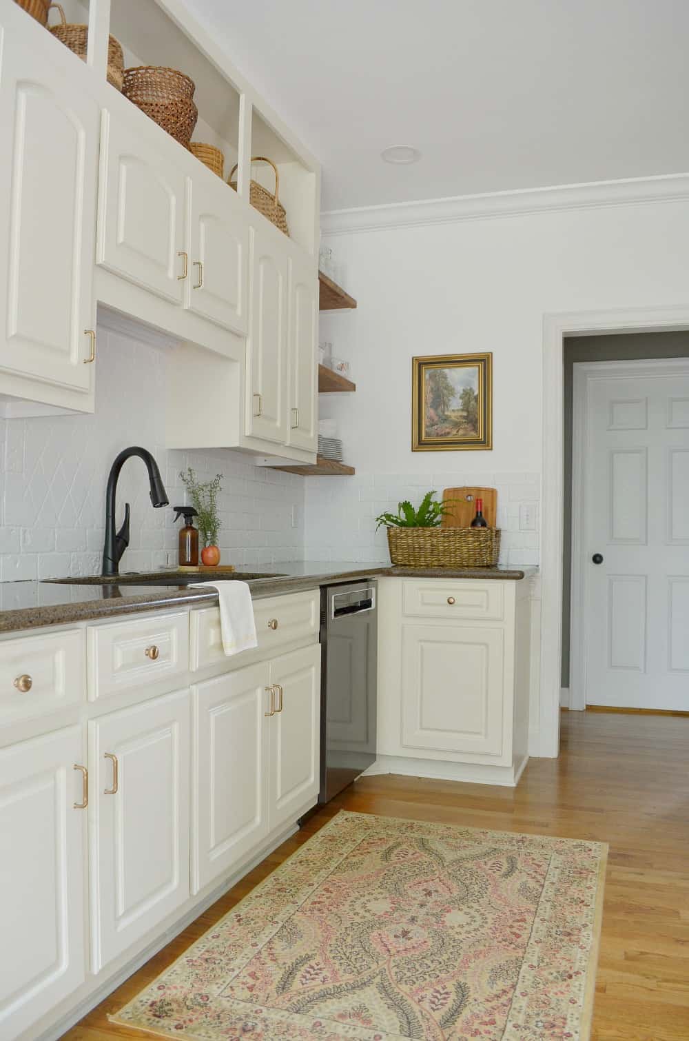 Clean kitchen sink view with glass amber bottle on counter