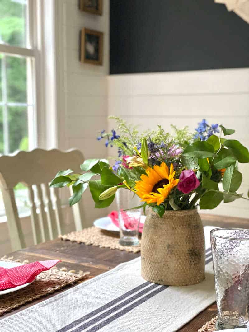 kitchen table with pottery case of fresh flowers