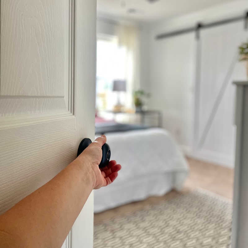 opening bedroom door to a clean and decluttered room