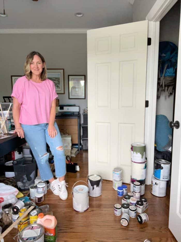 Sonya, creator at home with the barkers blog, standing with paint cans