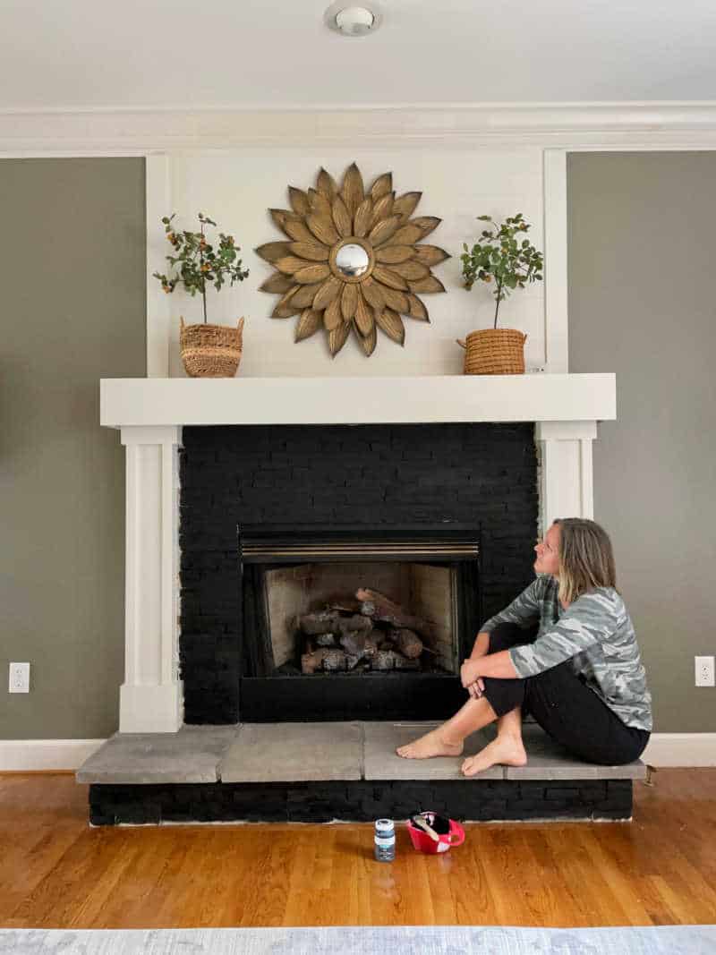 Sonya looking at the painted fireplace during the process