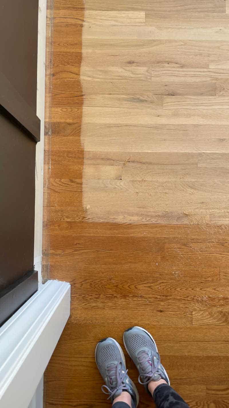 Hardwood Floor Refinishing during sanding showing stain and raw wood