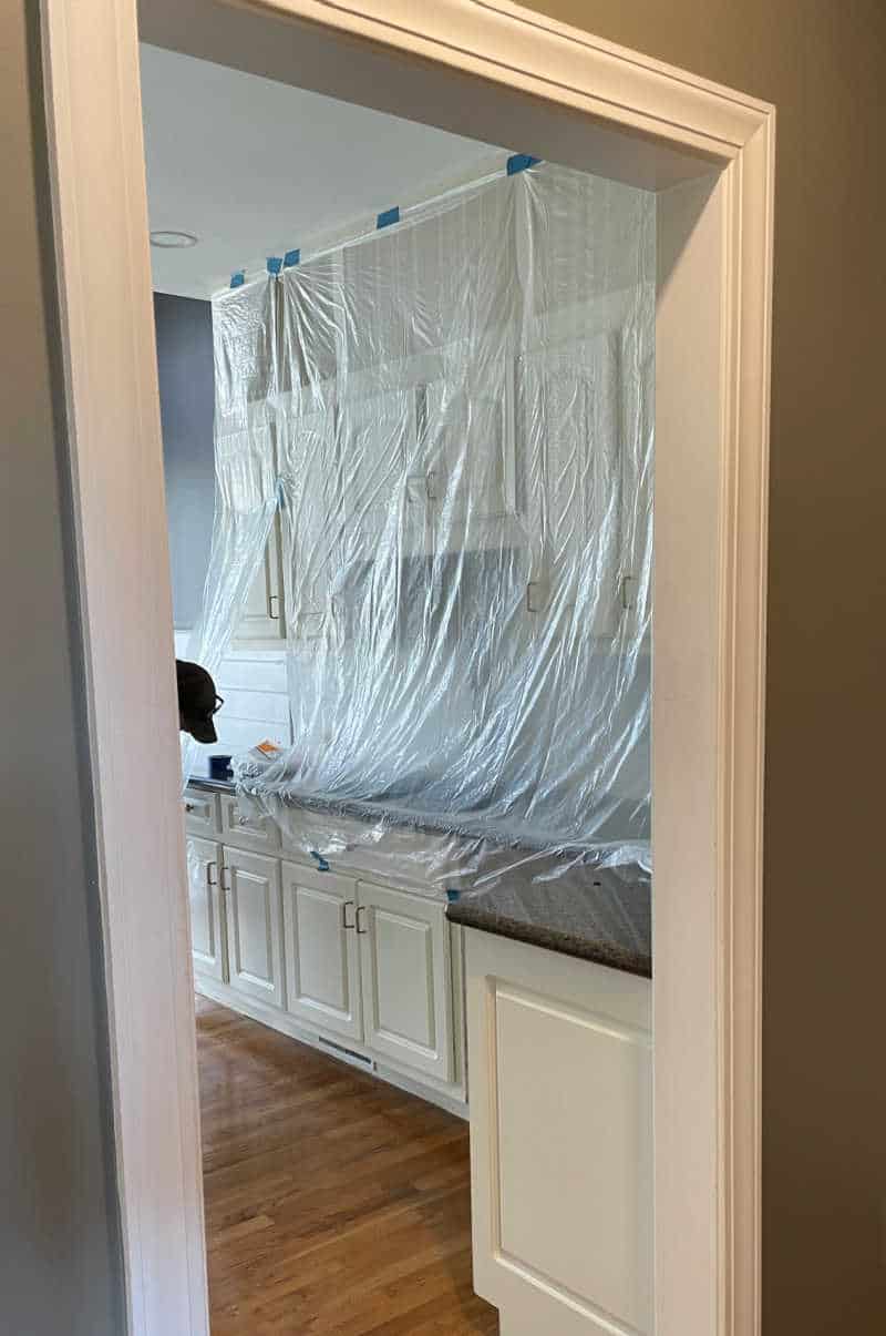 Plastic covered kitchen cabinets before hardwood refinishing