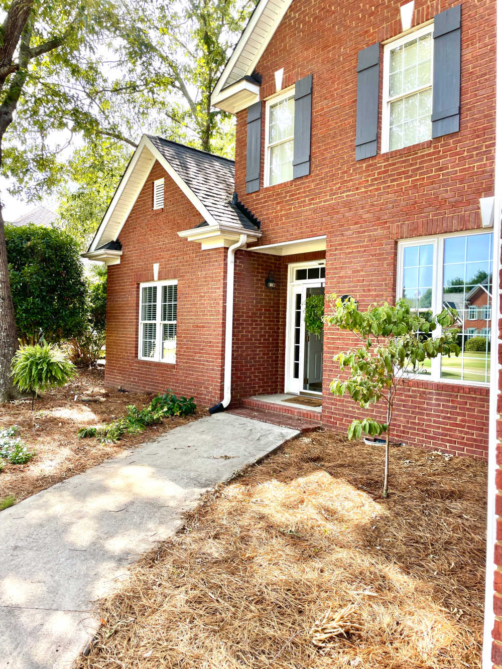 exterior home view with board and batten shutters home decorating project after