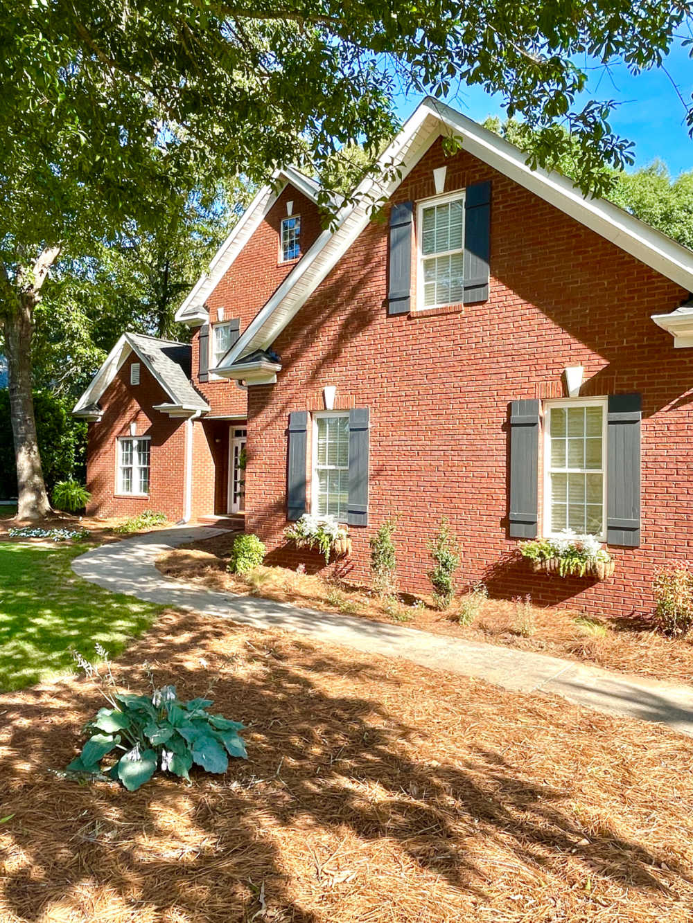 curb view of brick home and shutter placement project