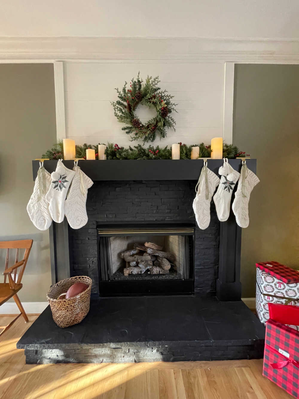 knit stockings hanging on black painted mantel