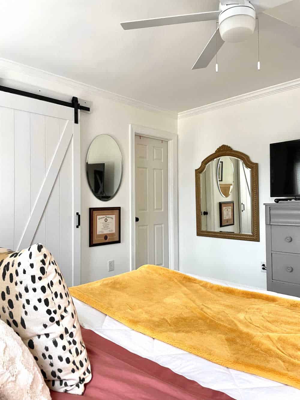 Bedroom with white walls and large wall mirror with rub n buff antique gold