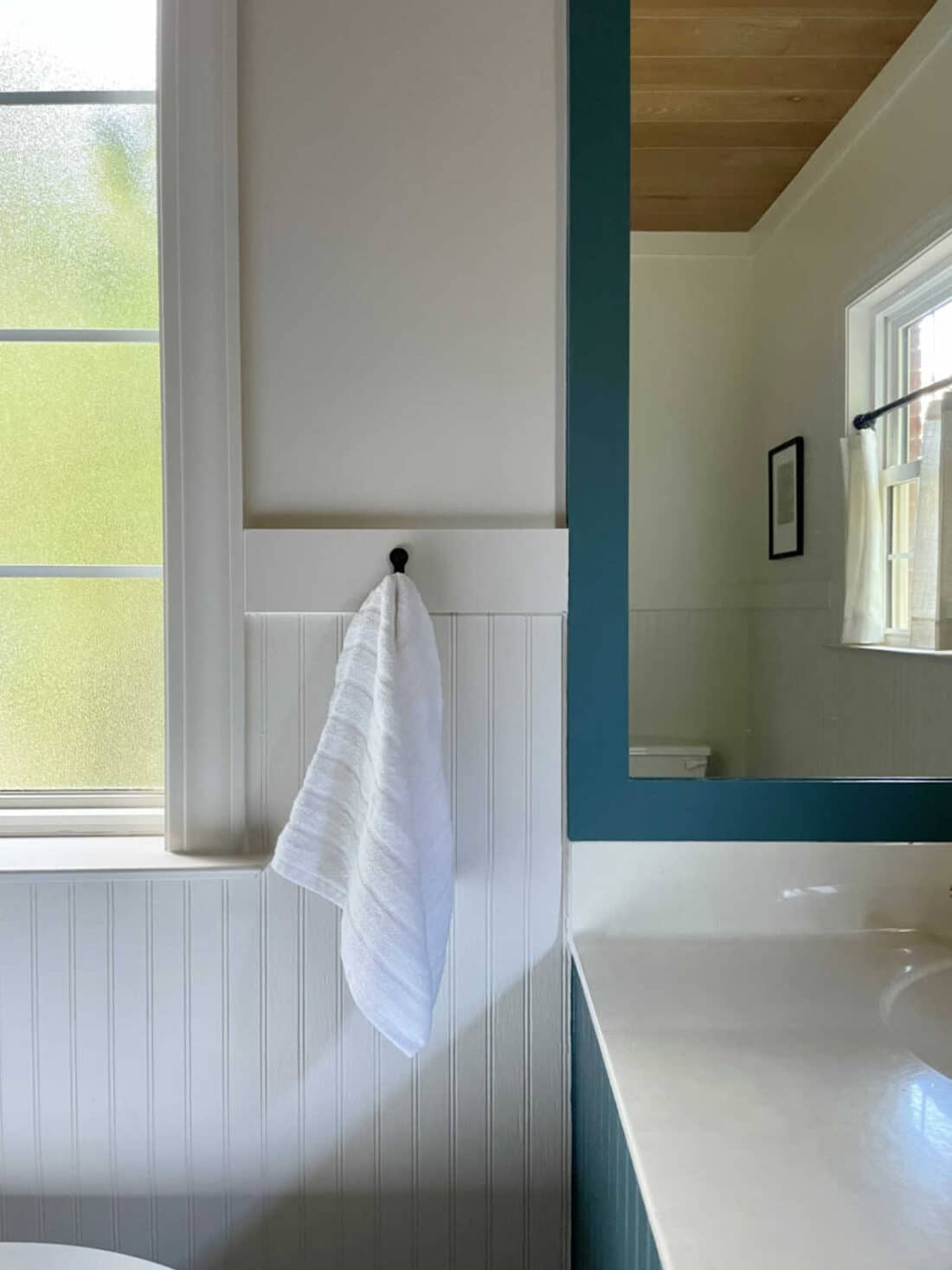 spa retreat bathroom with creamy whites and deep blue green colors