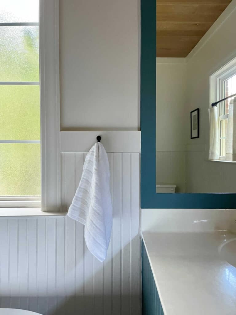 spa retreat bathroom with creamy whites and deep blue green colors