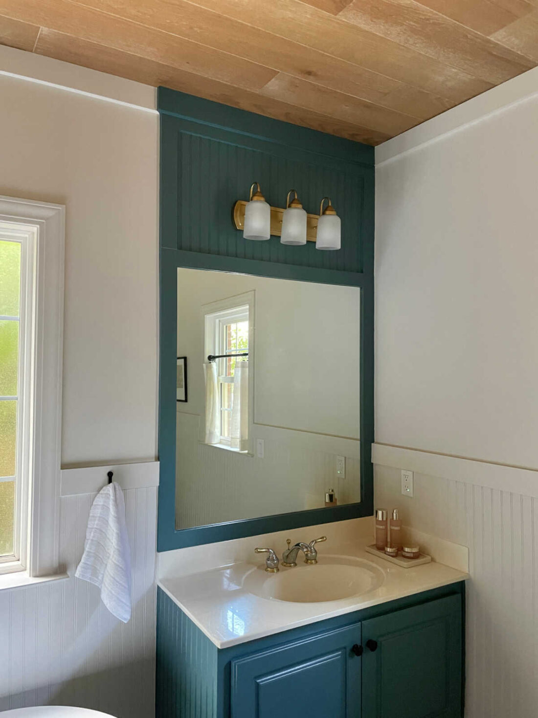 painted bathroom vanity and framed mirror