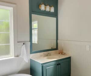 custom details added to bathroom vanity makeover with two doors, two drawers and floor to ceiling paint