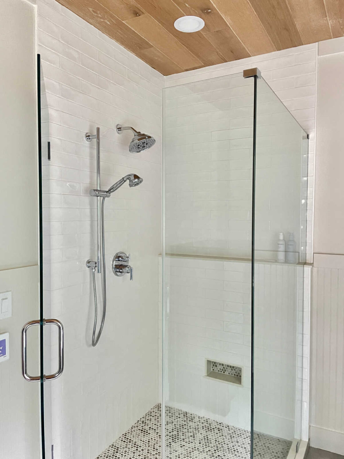 Shower with two sided glass door and polished chrome hardware
