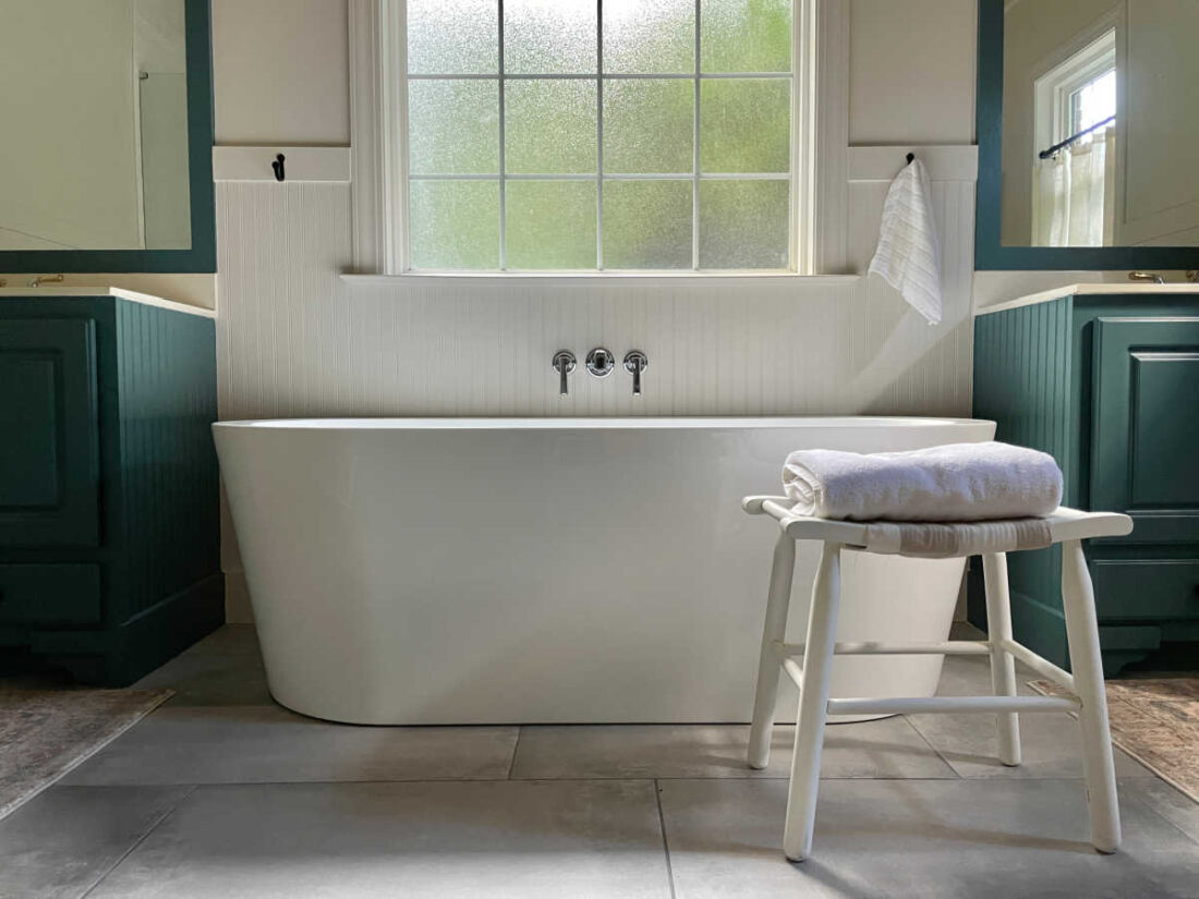 soaking tub with stool in bathroom remodel