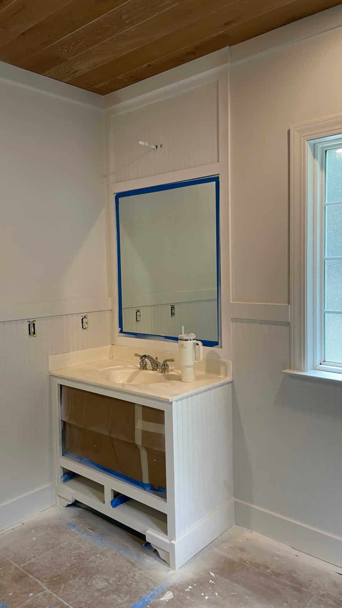 bathroom vanity primed white with added wood details