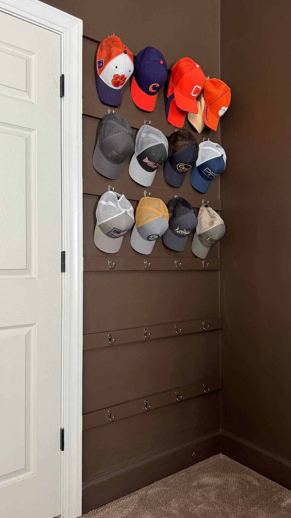 hat hook organizer behind the door in the master bedroom