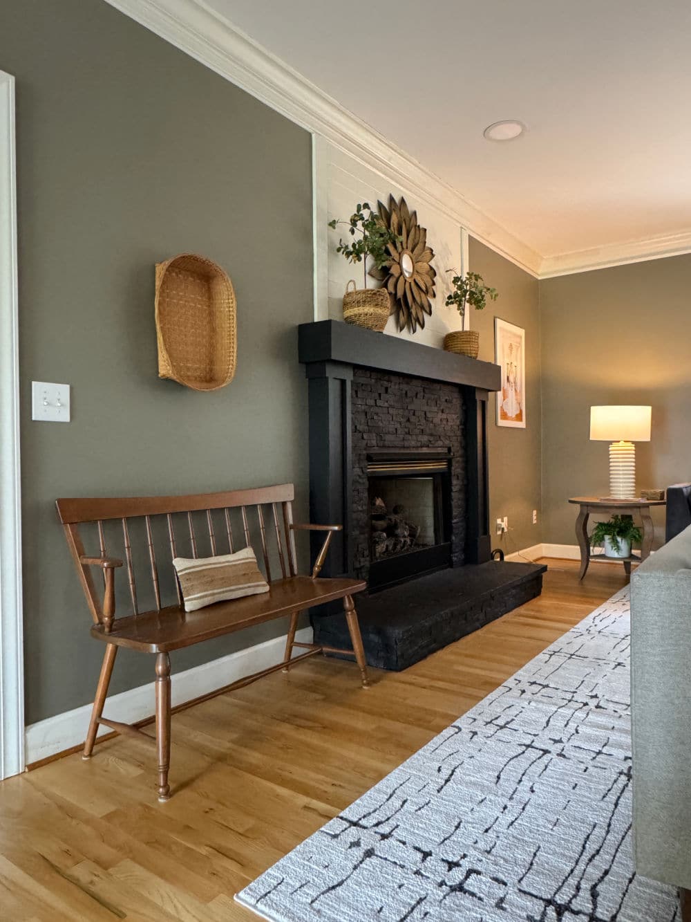living room fireplace with antique bench