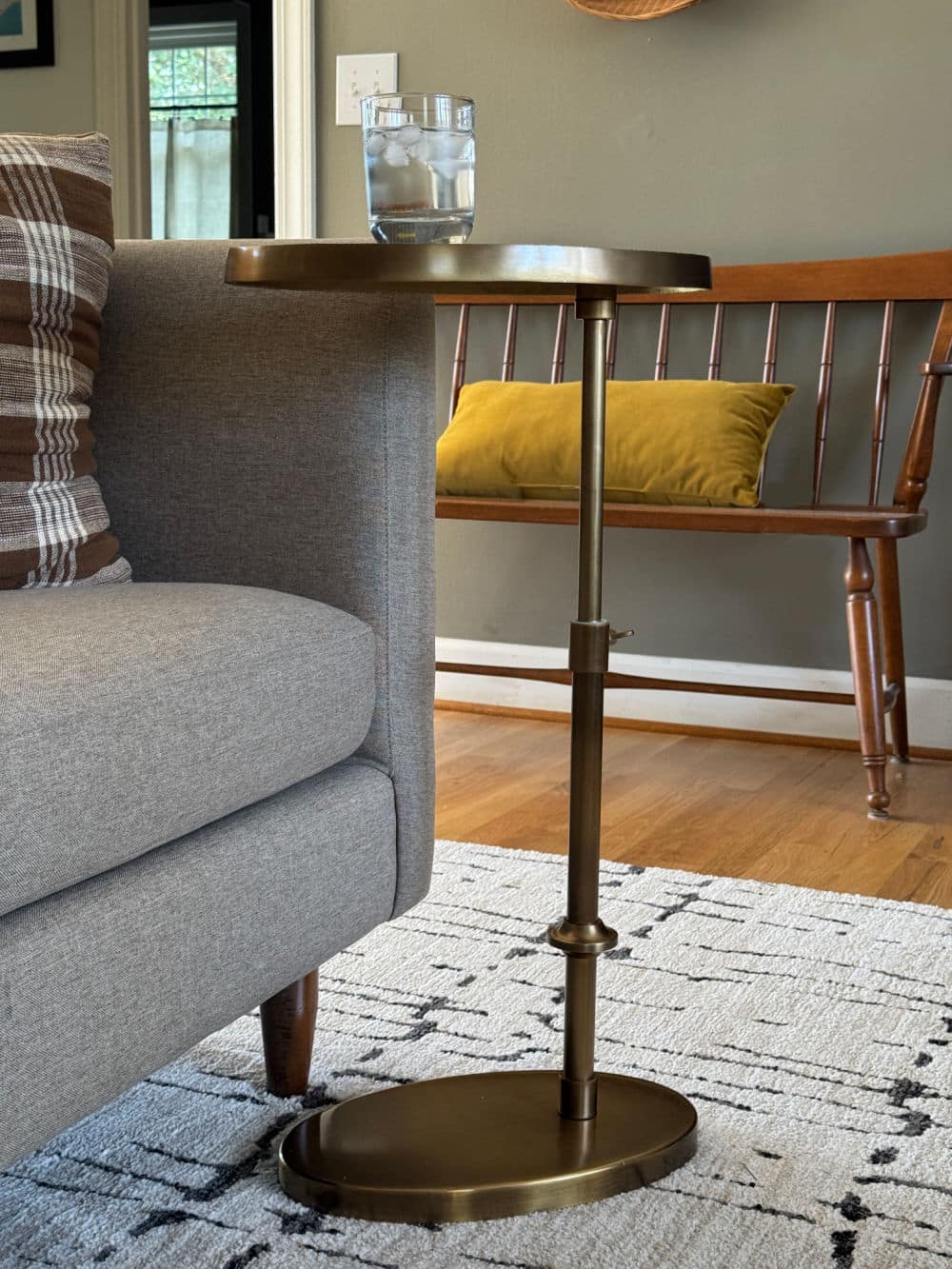 Adjustable height, c shaped, brass look side table in living room