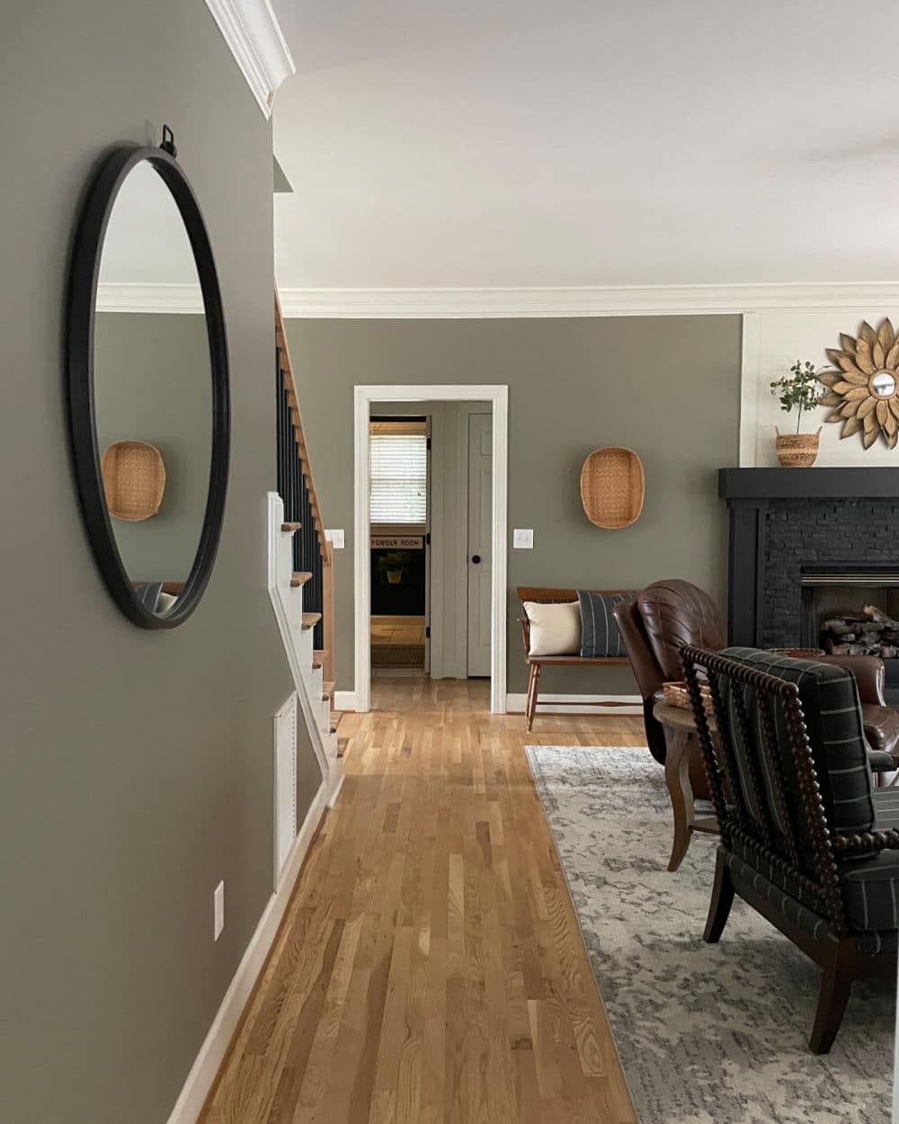 Living room hallway with round mirror