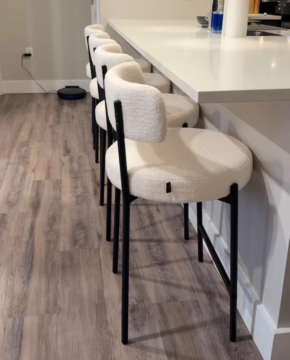 upholstered bar chairs neatly placed at bar
