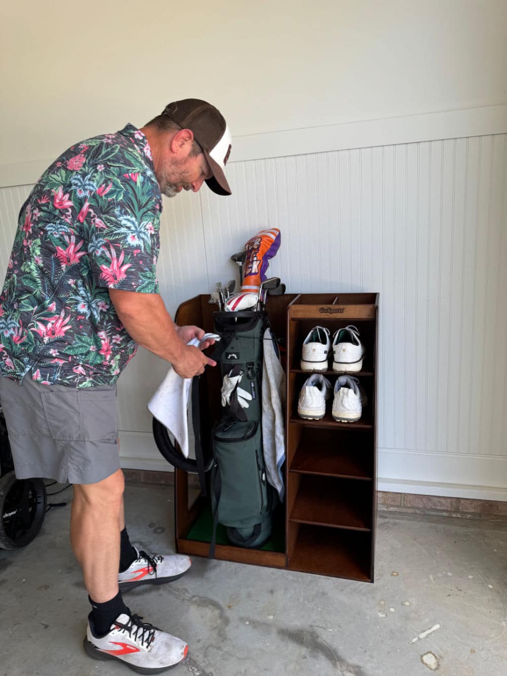Ray storing his golf bag away in his wooden golf organizing stand